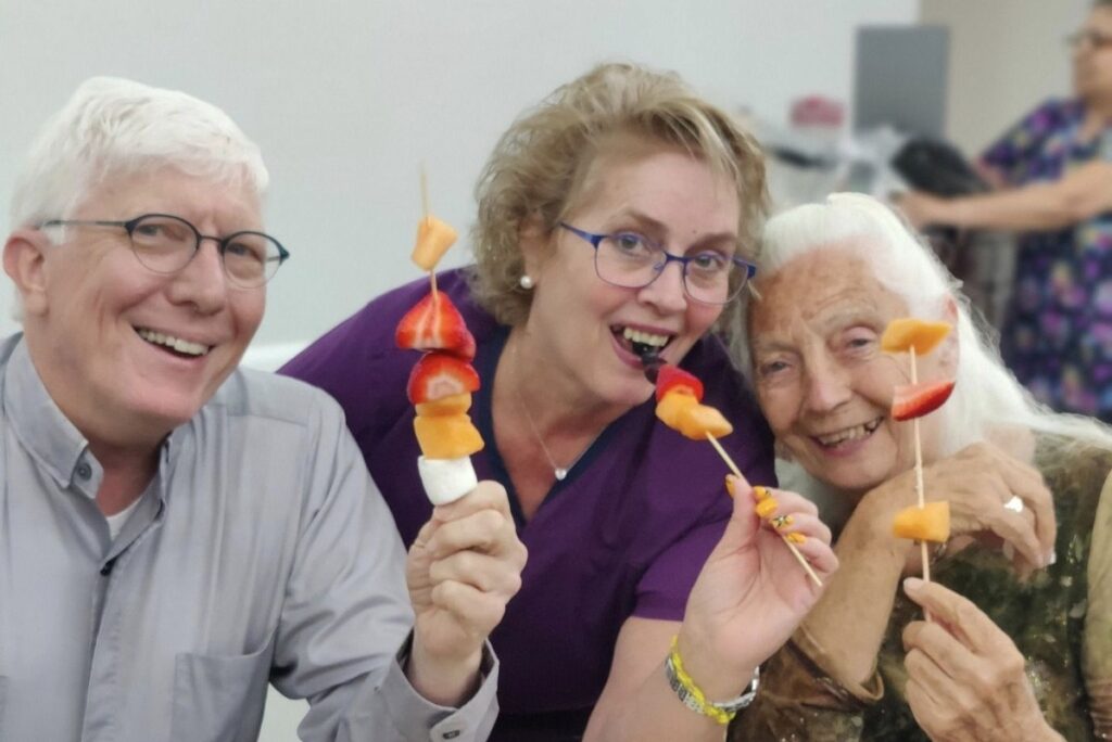 Barton House | Three residents with fruit kebabs